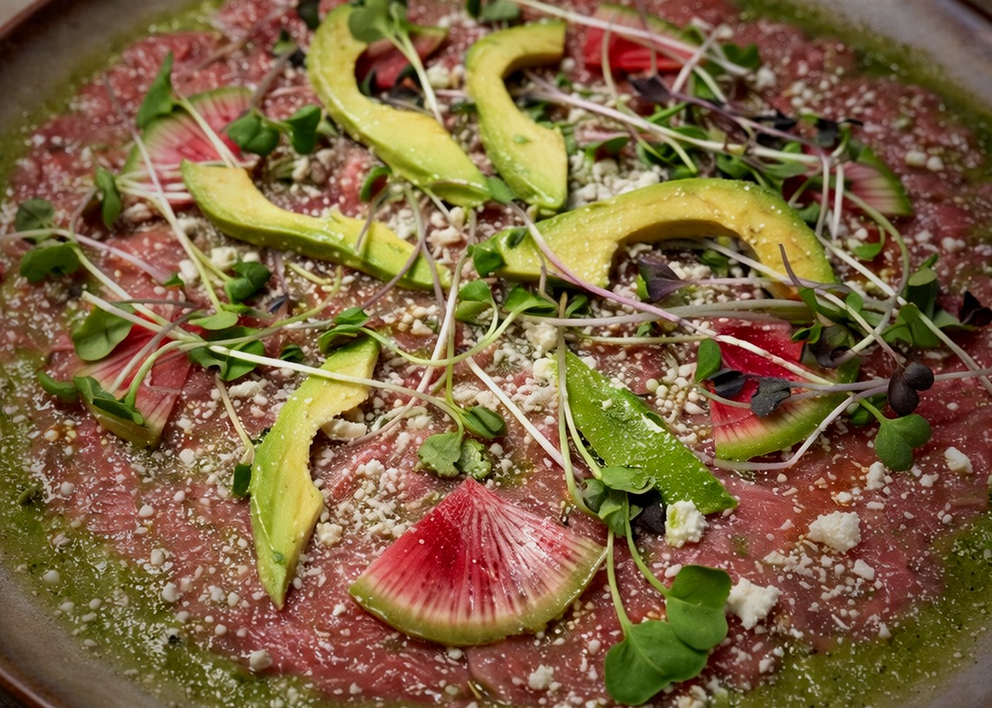 Carpaccio de Res — avocado, cotija, microgreens