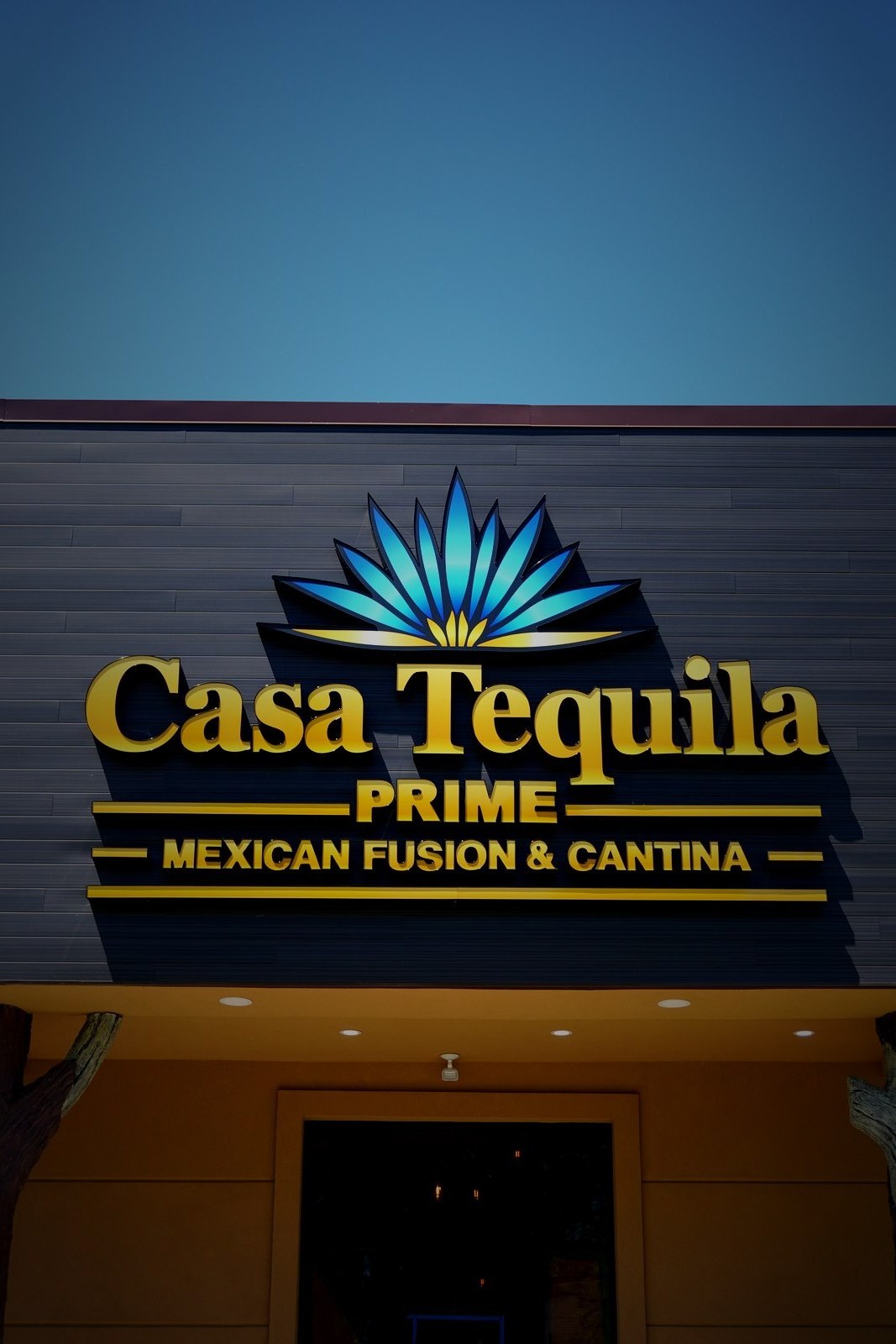 Casa Tequila Prime close-up exterior signage — gold and blue agave logo